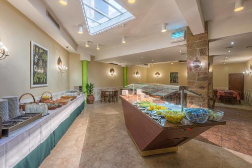 a buffet line in a hotel with food on display at Amazonia Lisboa Hotel in Lisbon