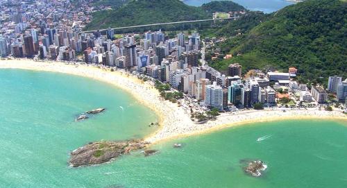 an aerial view of a city and a beach at Vila Suítes Coliving in Vila Velha