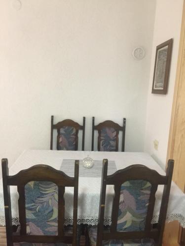 a dining room with a table and two chairs at Apartment Kantarije in Sarajevo