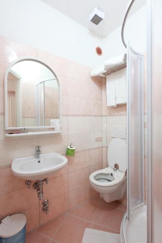a bathroom with a sink and a toilet and a mirror at Albergo Al Carugio in Monterosso al Mare