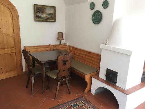 a dining room with a table and a fireplace at Terézia Vendégház in Tihany