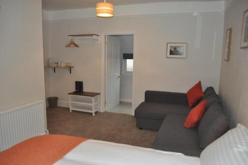 a living room with a couch and a bed at Woodlands 159 in Pershore