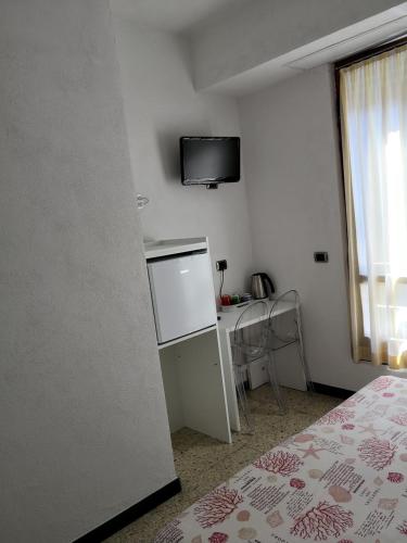 a bedroom with a white bed and white walls at Albergo Al Carugio in Monterosso al Mare