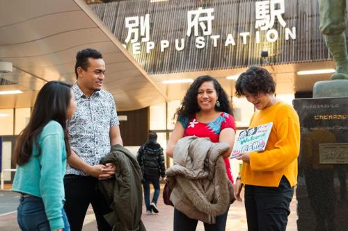a group of people standing in front of a building at Nogami Honkan in Beppu