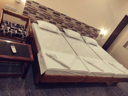 a bed in a room with a wooden frame at Hotel Wins in Kanyakumari