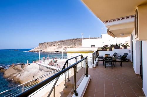 a balcony of a house with a view of the ocean at Apartments La Caleta Sunrises in Adeje
