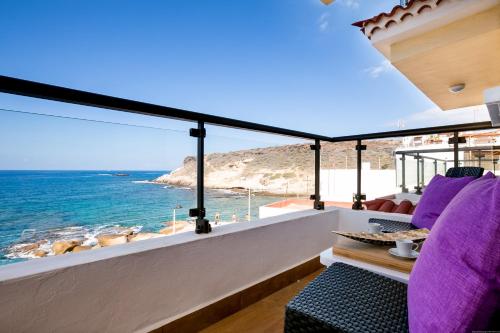 
a balcony overlooking the ocean with a view of the beach at Apartments La Caleta Sunrises in Adeje
