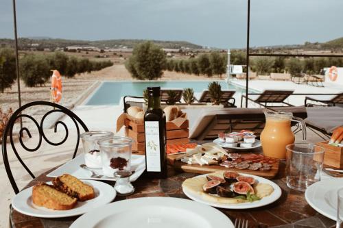 a table with plates of food and a bottle of wine at Agroturisme Gossalba in Sant Joan