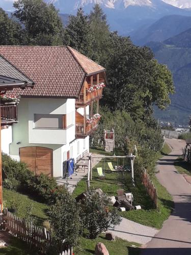 a house on the side of a mountain with a road at Roanerhof in San Genesio Atesino