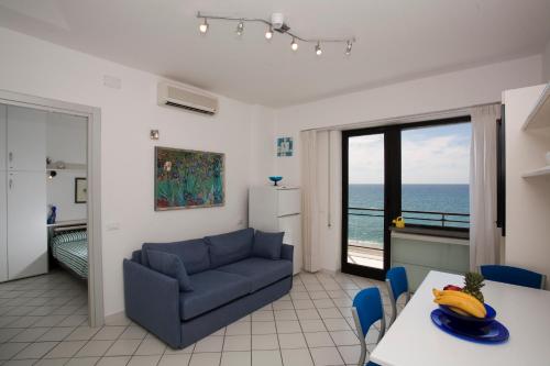 a living room with a couch and a table at Residence Le Dune Club in Varigotti