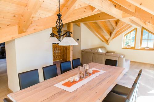 a dining room with a wooden table and chairs at Alpine Lodge Sölden - Chalet & Apart in Sölden
