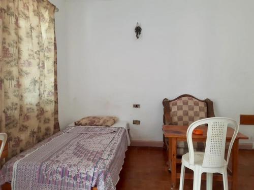 a bedroom with a bed and a table and chairs at Sina Star Camp in Nuweiba