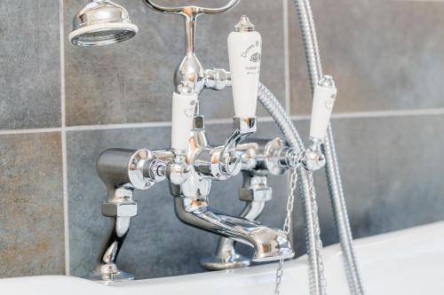 a chrome shower faucet in a bathroom at Alpine Lodge Sölden - Chalet & Apart in Sölden