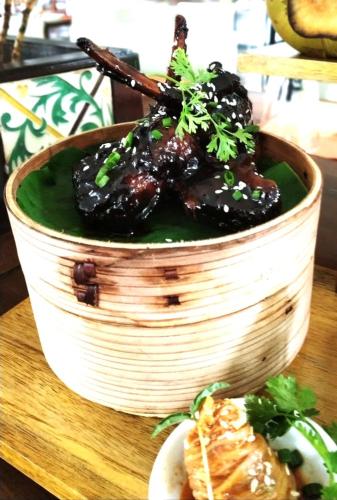 a bowl of food sitting on top of a table at Novotel Goa Dona Sylvia Resort in Cavelossim