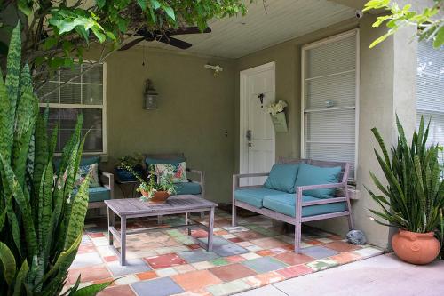 a porch with two chairs and a table and a door at Winter Park charm in Orlando