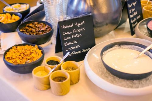 a table topped with bowls of food on a table at Schloss Hotel & Spa Pontresina in Pontresina