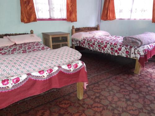 Postel nebo postele na pokoji v ubytování Vamoose Sukhim Homestay
