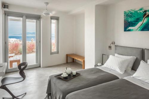 a bedroom with a bed with a tray on it at Luxury Villa Artemis by Mykonos Luxury in Elia Beach