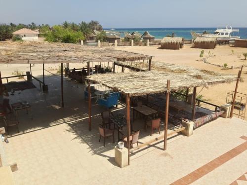 a large straw roof on top of a beach at Sina Star Camp in Nuweiba