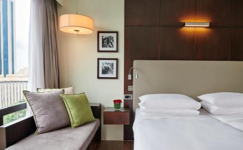 a hotel room with a bed and a couch at Hyatt Regency Dar es Salaam, The Kilimanjaro in Dar es Salaam