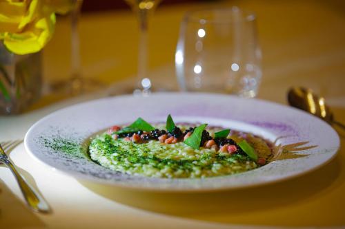 a white plate of food on a table at Schloss Hotel & Spa Pontresina in Pontresina