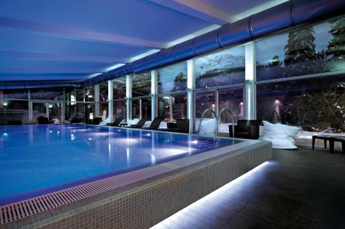 a swimming pool in a building at night at Schloss Hotel & Spa Pontresina in Pontresina