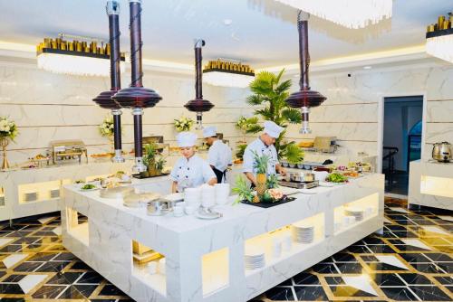 a group of chefs preparing food in a kitchen at Canh Hung Palace in Hai Phong