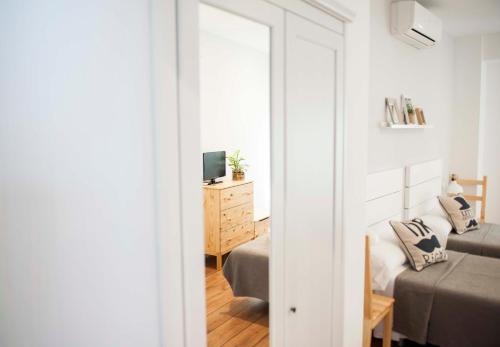 a bedroom with a bed and a mirror at Hotel Smile & Co Hostal Boutique in Alicante
