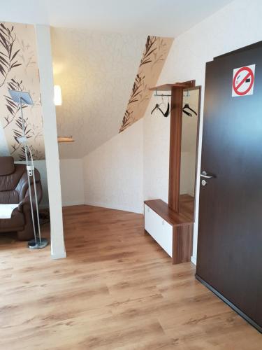 a room with a staircase and a door in a room at Deichgraf in Husum