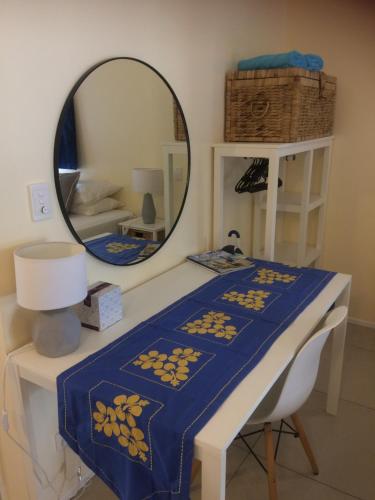 a table with a mirror and a blue blanket on it at Shoreline Escape Rarotonga in Rarotonga