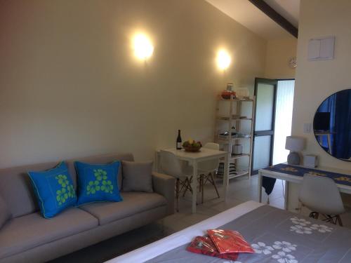 a living room with a couch and a table at Shoreline Escape Rarotonga in Rarotonga