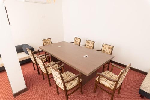 a conference room with a wooden table and chairs at Pearl Royal Hotel, Colombo in Colombo