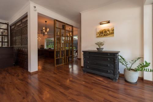 a living room with a dresser and a room with at Pearl Royal Hotel, Colombo in Colombo