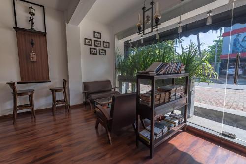 a room with a table and chairs and a window at Pearl Royal Hotel, Colombo in Colombo