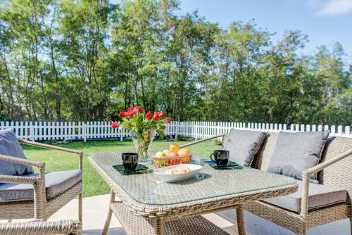 a table with a bowl of fruit on a patio at Bucharest Airport Suites & Villas in Otopeni