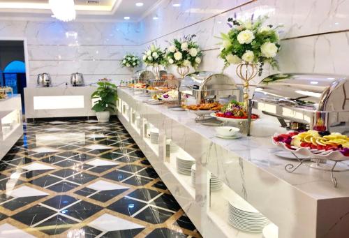 a buffet line in a hotel with food at Canh Hung Palace in Hai Phong