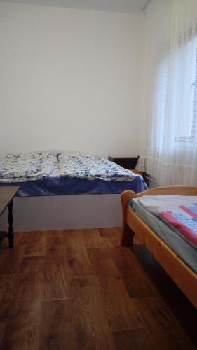 a bedroom with two beds and a wooden floor at Хижа Люляка in Kostinbrod