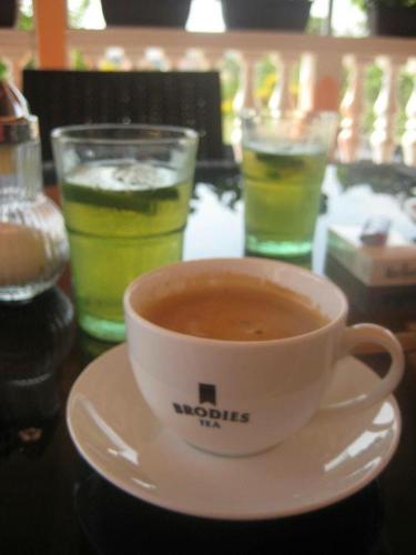a cup of coffee on a plate on a table with drinks at Villa Natalija in Medulin