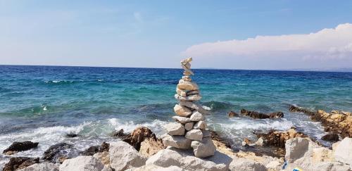 a stack of rocks on the shore of the ocean at Villa Natalija in Medulin