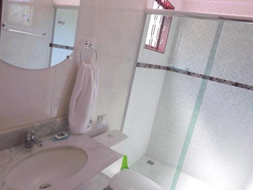 ein Badezimmer mit Waschbecken und Spiegel in der Unterkunft Pousada Igarapé in Socorro