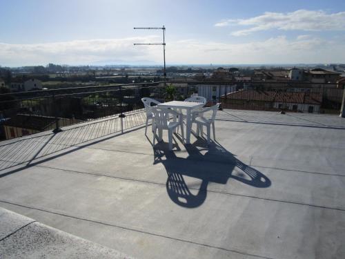 a table and two chairs sitting on top of a roof at San Marco in Pisa