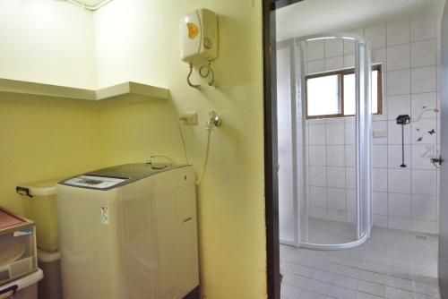a small bathroom with a sink and a shower at 博愛泊旅讀心境 in Hualien City