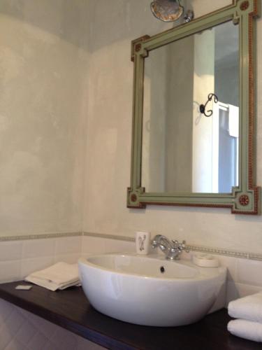 a bathroom with a white sink and a mirror at il casale san martino in Norcia