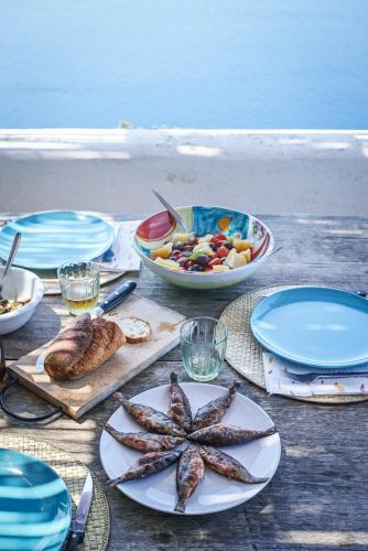 a table topped with plates of food and a starfish at Dammuso sulla scogliera - Pantelleria in Scauri