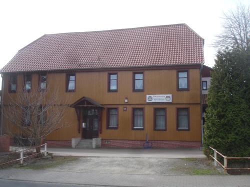 a large brown building with a brown roof at Harzer Ferienpension in Timmenrode