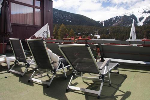 a group of chairs sitting on top of a roof at Hotel Amoretes in La Molina