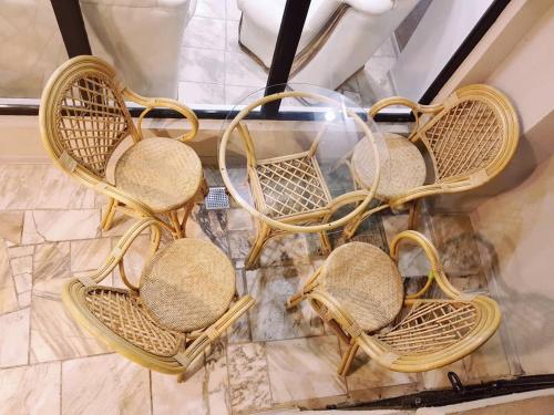 a group of rattan chairs sitting on a floor at Hotel Classic in Tbilisi City