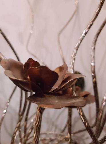 a wooden flower sitting on top of a metal chair at Hotel Classic in Tbilisi City