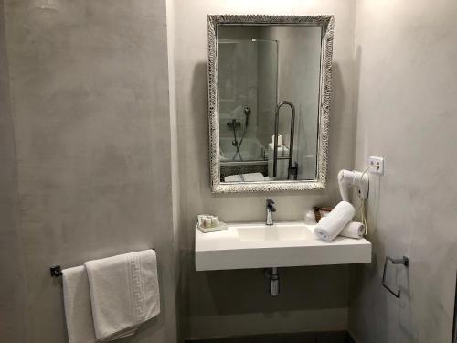 a bathroom with a sink, toilet and mirror at Hotel Capri in Sitges