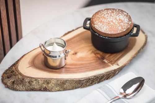 a wooden tray with a cup of coffee and a cup of cocoa at L'Échappée - Hôtel Casino Dieppe in Dieppe
